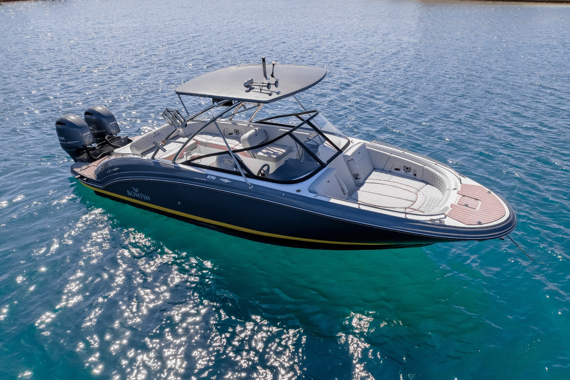 Bowfin 270 with twin outboards on shimmering water