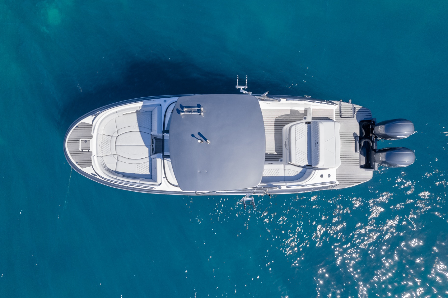 Top-down of Bowfin with covered deck on deep blue water